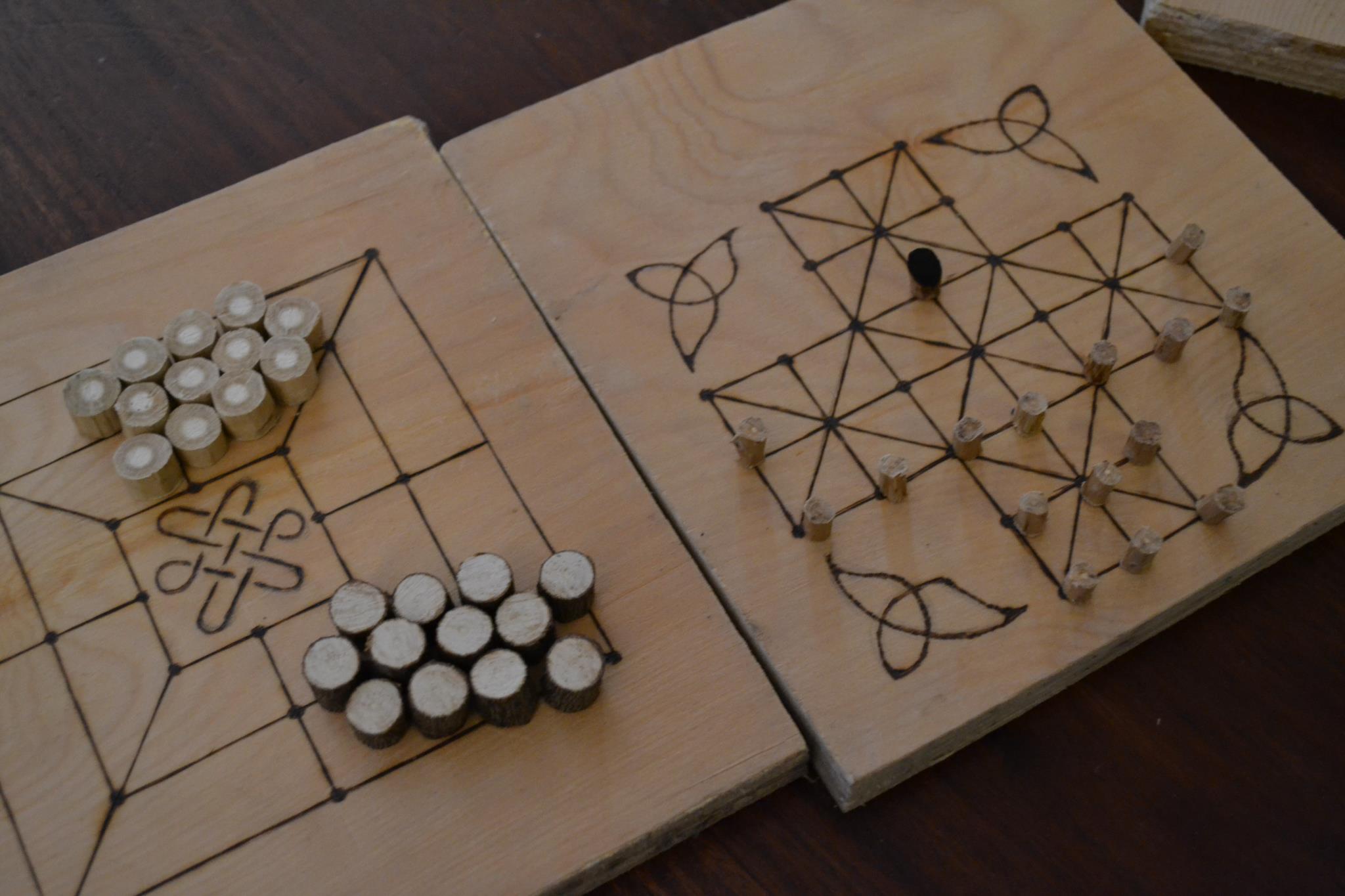 Two boards for traditional tabletop games, with counters on them